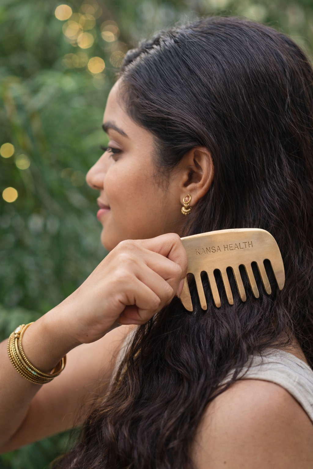 Hand holding Kansa Bronze Head Massage Comb for Ayurvedic Scalp Therapy