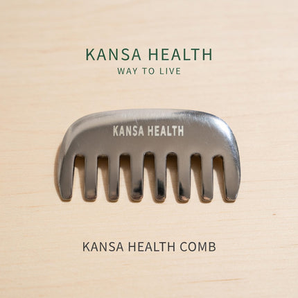 Hand holding Kansa bronze head massage comb for scalp stimulation