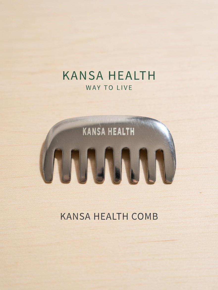 Hand holding Kansa bronze head massage comb for scalp stimulation
