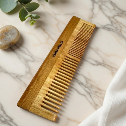 Natural neem wood comb distributing scalp oils for healthy shiny hair