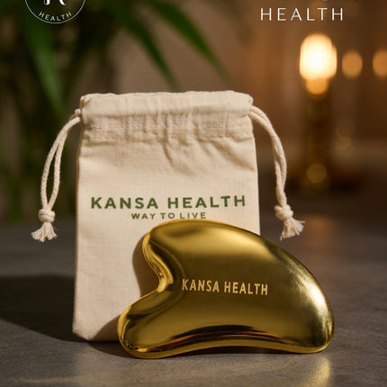 Woman using Kansa gua sha tool for facial massage and lymphatic drainage