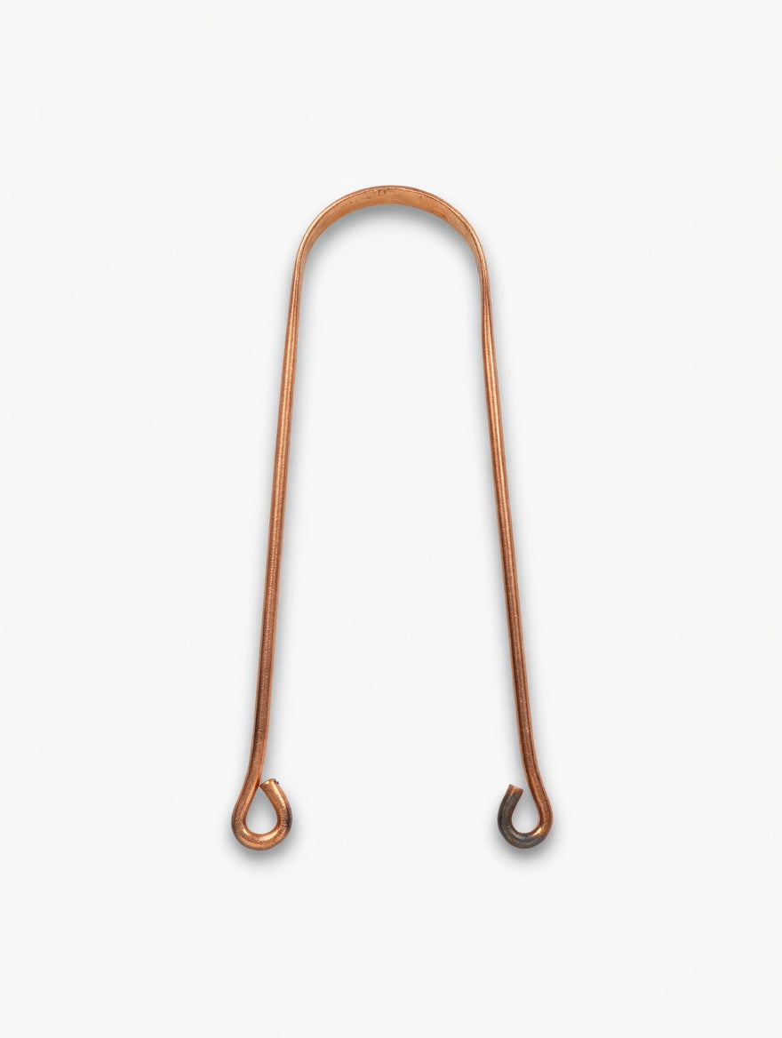 close up of pure copper tongue cleaner mindi showing smooth curved design